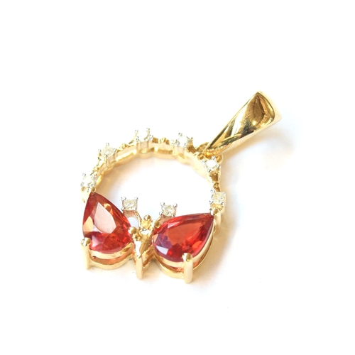 56 - A 9ct gold pendant in the form of a butterfly set with rubies and diamonds, the two pear shaped Song... 