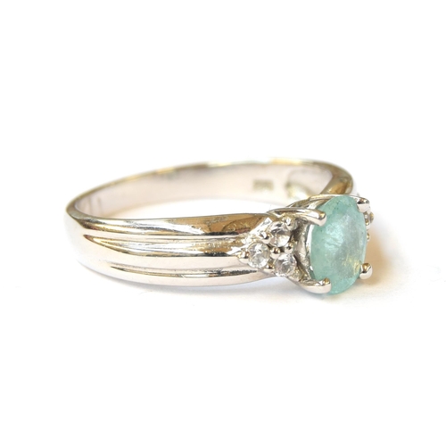 70 - A 9ct white gold ring set with a paraiba tourmaline and white sapphires, the Brazilian tourmaline 0.... 