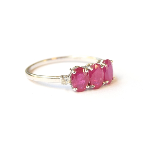 74 - A 9ct white gold ruby and white zircon trilogy ring, the Montepuez rubies totalling 1.8cts, size P 1... 