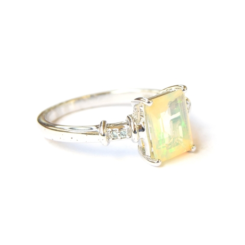 98 - A sterling silver ring set with an opal and alexandrite, the octagonal cut Ethiopian opal 1.3cts and... 