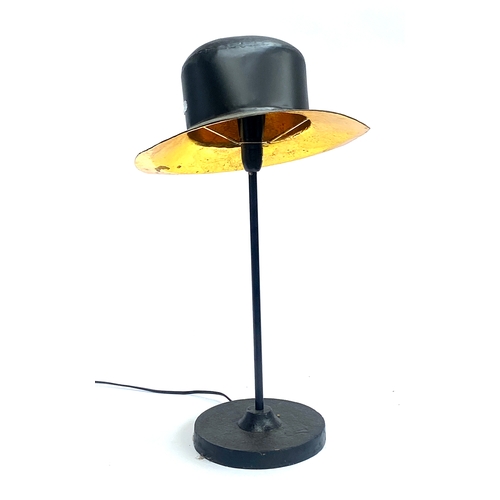 668 - A black and gold painted table lamp, in the form of a hat, 60cmH