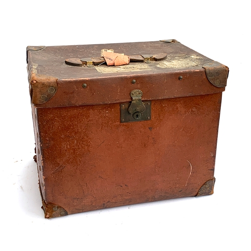 656 - An early 20th century Army & Navy Makers Westminster red travel trunk with leather bracing and handl... 