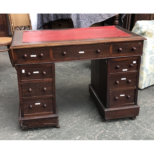 620 - A small pedestal desk, with the traditional arrangement of nine drawers, 104cmW