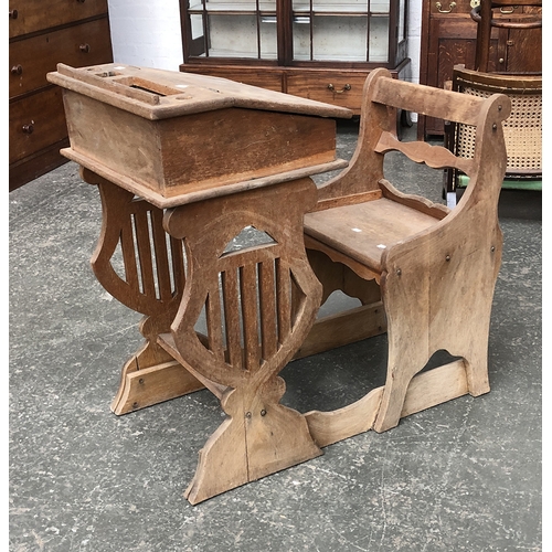 624 - An oak school desk and chair with lyre supports, 86cmH