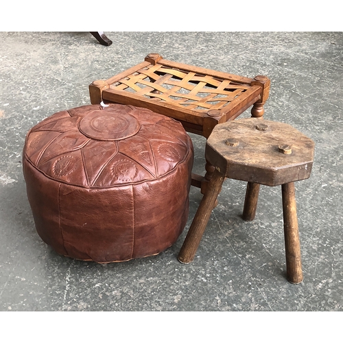 629 - A three legged milking stool with octagonal top 32cmH; together with a leather pouffe; and a further... 