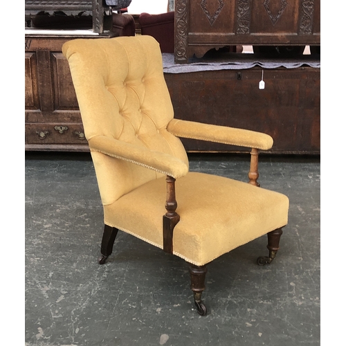 646 - A 19th century mustard yellow button upholstered open armchair, turned underarm supports, on turned ... 