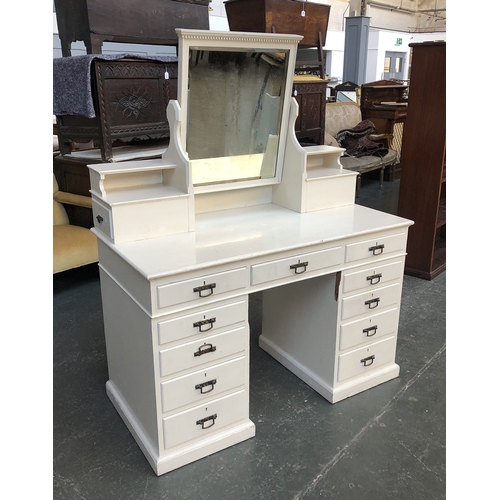 671 - A white painted pedestal dressing table, adjustable mirror supported on two piers, having 11 drawers... 