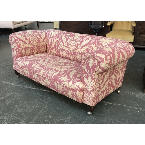 678 - A Chesterfield sofa upholstered in a red and gold acanthus print, 165cmW