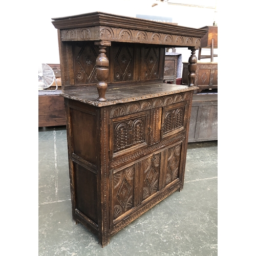 686 - A 17th century oak court cupboard, with demilune lozenge carving, cup and cover supports, over cupbo... 