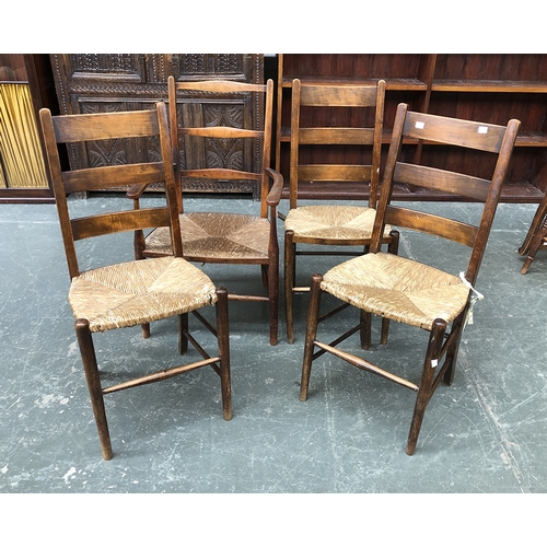 699 - Three ladder back side chairs with rush seats; together with an open armchair with rush seat