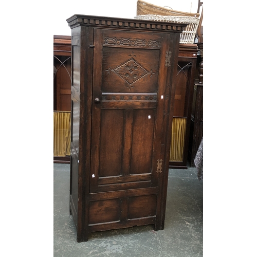 703 - A panelled oak wardrobe with single door with lozenge carving, 84x50x174cmH