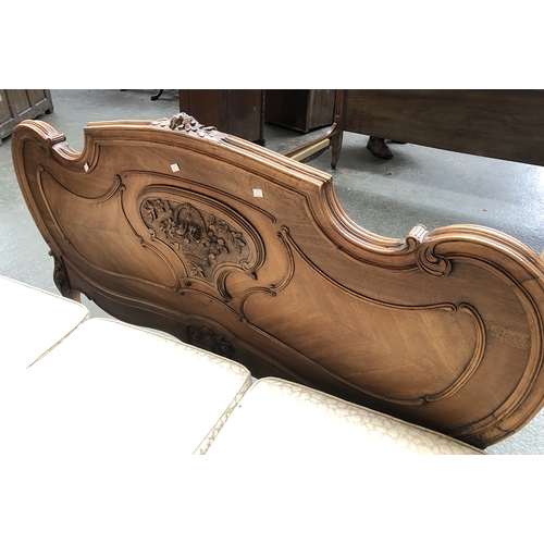 707 - A continental double bed with carved Rococo cresting, 153cmW, width between rails 132cm, the foot 90... 