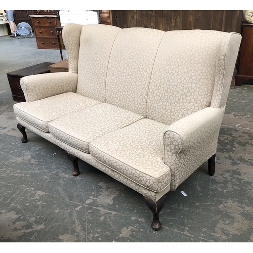 708 - A three seater wingback sofa on cabriole legs, 176cmW