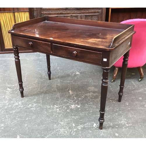 719 - A Regency mahogany three quarter gallery writing table, with two frieze drawers, on lotus and ring t... 