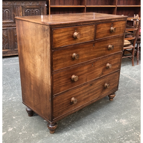 723 - A 19th century mahogany chest of two short over three long drawers, turned oak knobs, on turned feet... 