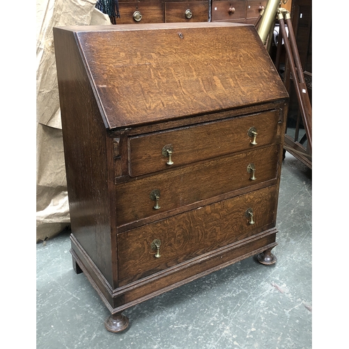 738 - A 20th century oak bureau, fall front over three drawers, 77cmW