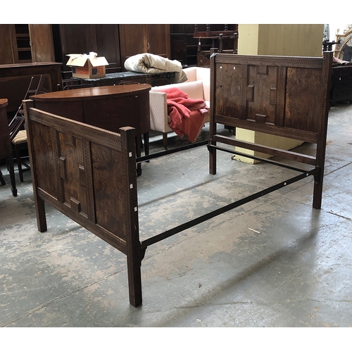 755 - A carved burr oak double bed with central geometric panel, 137cmW the foot 102cmH the headboard 134c... 