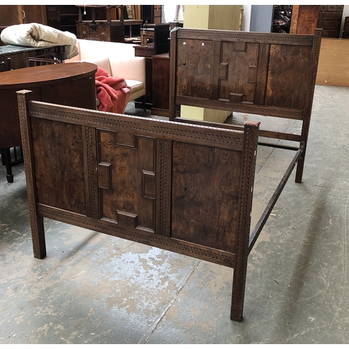 755 - A carved burr oak double bed with central geometric panel, 137cmW the foot 102cmH the headboard 134c... 