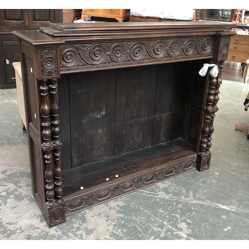 759 - An oak bookcase with two adjustable shelves and turned columns, 147cmW