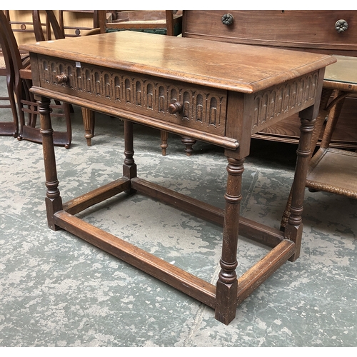 791 - A carved oak side table with single drawer, on ring turned legs joined by peripheral stretchers, 96x... 