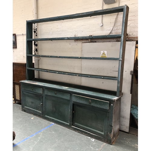 799 - A massive Victorian country house pine kitchen dresser painted green, the rack with four shelves ove... 