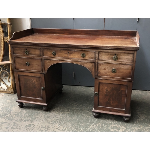 805 - A Victorian kneehole desk, three quarter gallery top, over and arrangement of five drawers with cupb... 