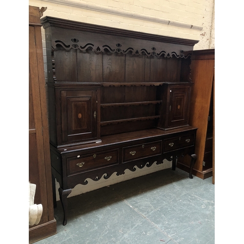 815 - A George III oak kitchen dresser, the rack with moulded pediment over a pierced apron, the two cupbo... 