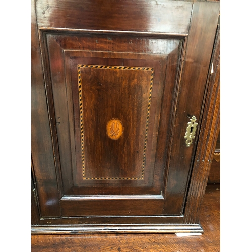 815 - A George III oak kitchen dresser, the rack with moulded pediment over a pierced apron, the two cupbo... 