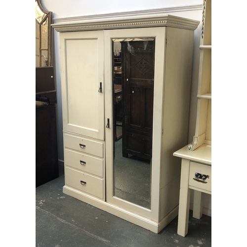 817 - An early 20th century white painted compactum wardrobe, dentil cornice over slides, drawers and long... 