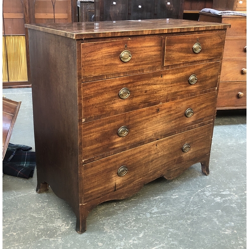 714 - A Regency mahogany and line inlaid chest of two short over three long drawers, on shaped apron and s... 