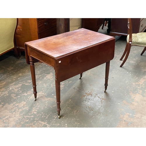 778 - A Regency mahogany Pembroke table, with single end drawer, on turned tapering legs and brass casters... 