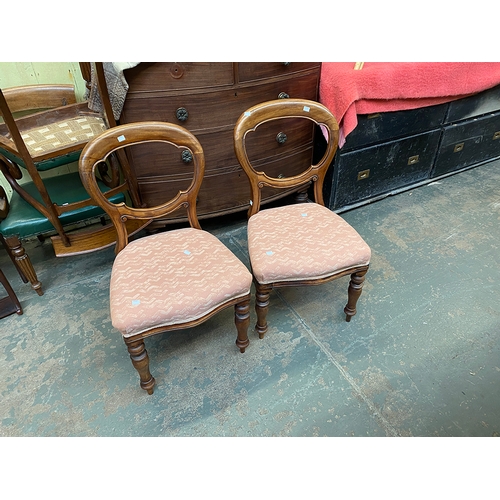 782 - A pair of Victorian balloon back rosewood sideachairs, carved midrails, button upholstered stuffover... 