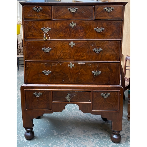 788 - An early 18th century walnut veneer chest on stand, later oak top, over three short and three long c... 