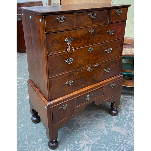 788 - An early 18th century walnut veneer chest on stand, later oak top, over three short and three long c... 