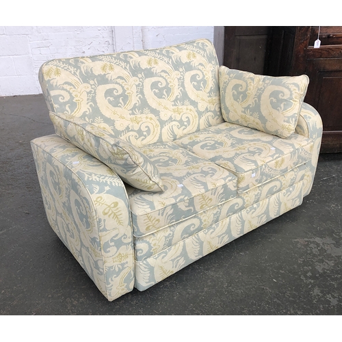 622 - A two seater sofa upholstered in a green fern fabric, 135cmW