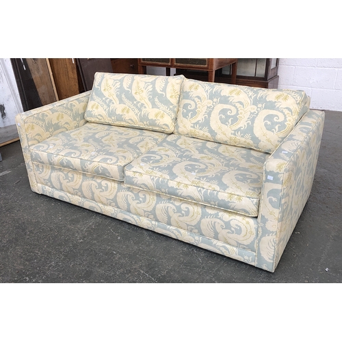 623 - A three seater sofa bed upholstered in a fern fabric, 170cmW