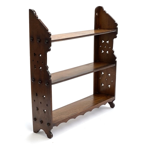 724 - A late Victorian Aesthetic period small wall hung set of walnut shelves, 57cmH