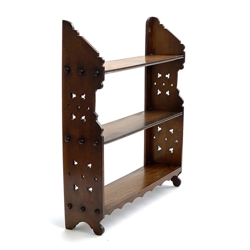 724 - A late Victorian Aesthetic period small wall hung set of walnut shelves, 57cmH