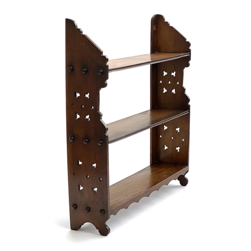 724 - A late Victorian Aesthetic period small wall hung set of walnut shelves, 57cmH