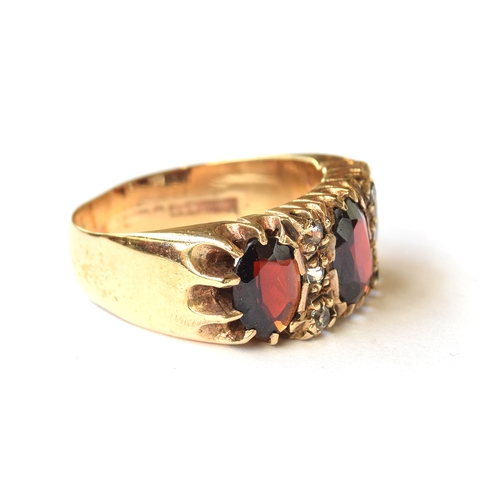 113 - A substantial 9ct gold ring set with garnets and clear stones, size O 1/2, 6.6g