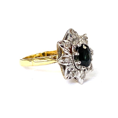 115 - An 18ct gold star shaped ring set with a central sapphire surrounded by diamonds, size L 1/2, 6.3g