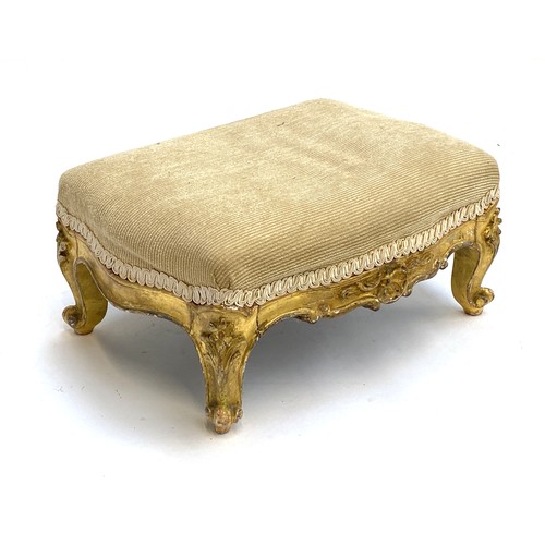 642 - A small 19th century gilt gesso French footstool, upholstered top on a carved and gilded base with c... 