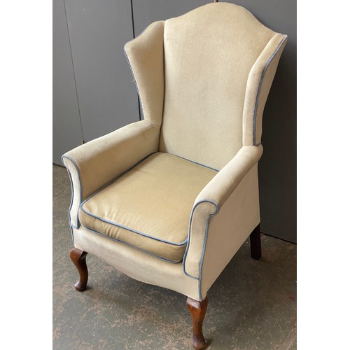 826 - A 20th century wingback armchair, on cabriole legs, 69cmW