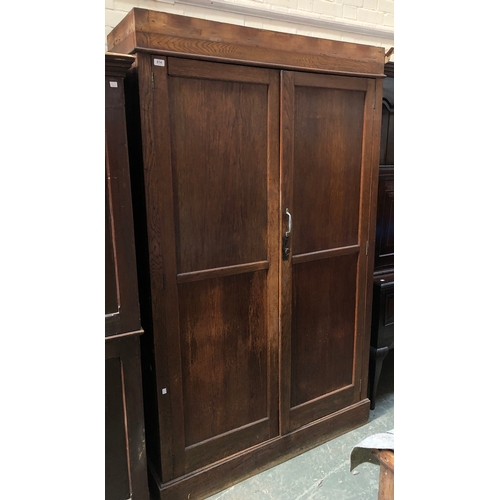 814 - A shallow oak larder cupboard, two panelled doors opening to five shelves, 125x47x209cmH