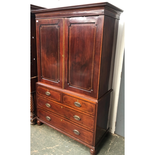 822 - A 19th century mahogany and line inlaid linen press, panelled doors with reentrent corners, two shor... 