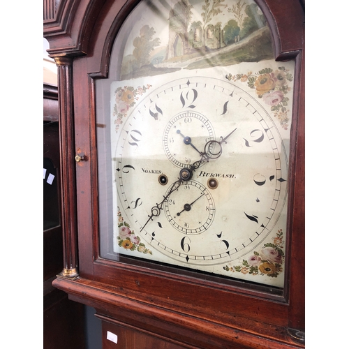 828 - A mahogany longcase clock, with three ball finials over a domed painted dial, signed Noakes Burwash