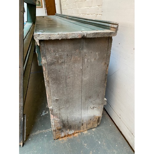 799 - A massive Victorian country house pine kitchen dresser painted green, the rack with four shelves ove... 