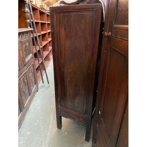 702 - A Chinese hardwood cabinet, the doors carved in low relief with dragons, 92x42x134cmH