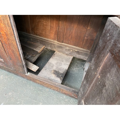 621 - An oak court cupboard, first half 18th century, the central panel inscribed WHM 1732, 154cm high, 14... 