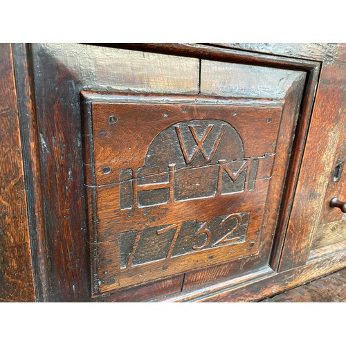 621 - An oak court cupboard, first half 18th century, the central panel inscribed WHM 1732, 154cm high, 14... 